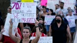 FILE - Protesters march around the Arizona Capitol in Phoenix after the Supreme Court decision to overturn Roe v. Wade, Friday, June 24, 2022. A new Arizona law banning abortions after 15 weeks of pregnancy takes effect Saturday, Sept. 24, 2022 as a judge weighs a request to allow a pre-statehood law that outlaws nearly all abortions to be enforced. (AP Photo/Ross D. Franklin, File)