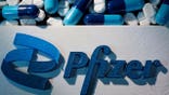 Pfizer logo and pills