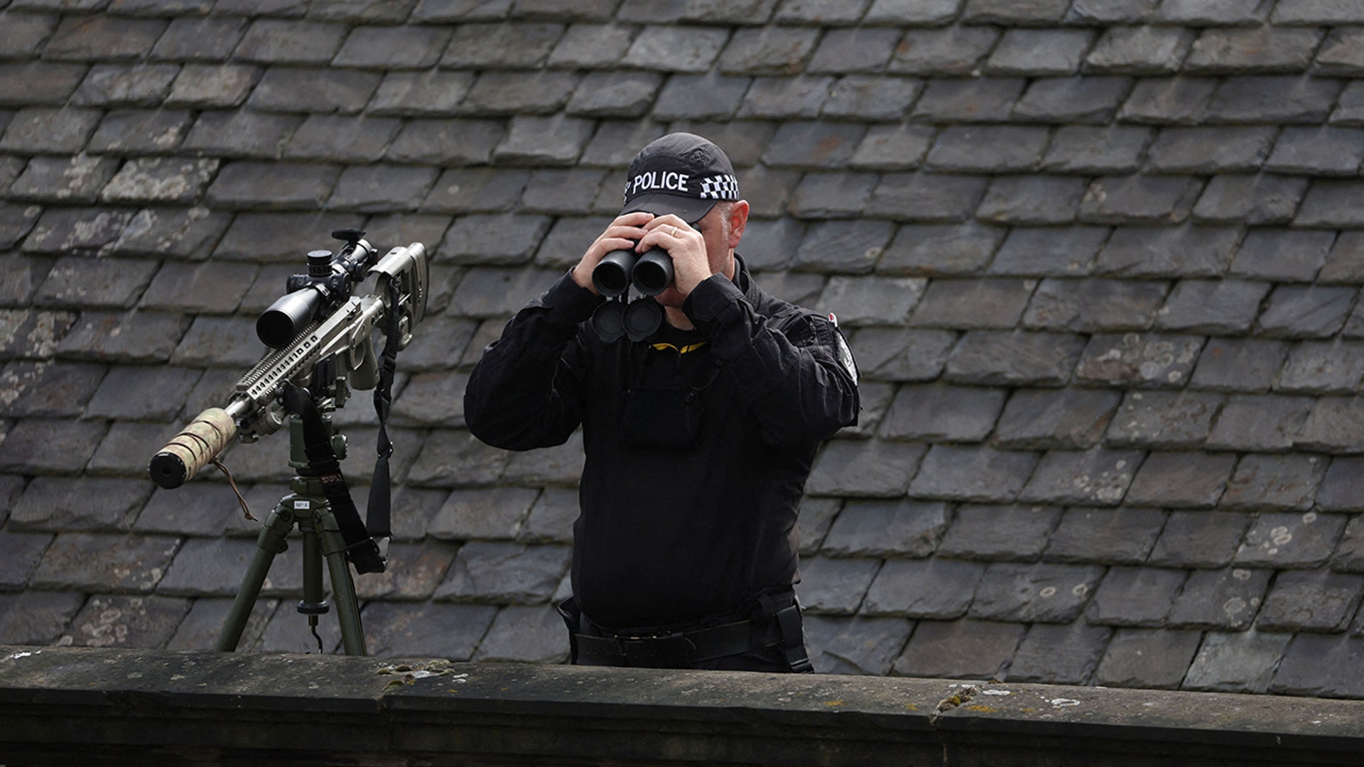A police officer looks at St Giles' Cathedral, in Edinburgh