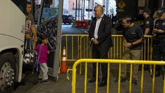 Migrant bus arrives in New York City, greeted with handshakes, blankets