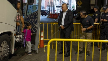 Migrant bus arrives in New York City, greeted with handshakes, blankets