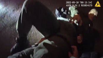Las Vegas police body cam footage shows officer take down suspect after she's knocked to the ground by bullet