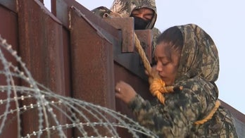 Video captures migrants in camo scaling Arizona wall after Harris says border secure