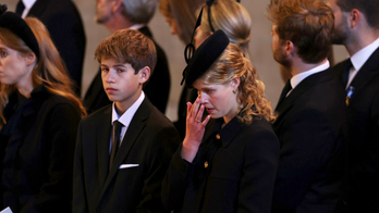 Queen Elizabeth II's youngest grandchild, James, Viscount Severn, 14, stands vigil at her coffin