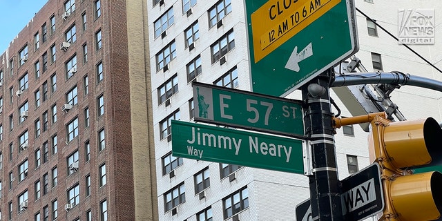 A street sign is unveiled on Wed., Sept. 14, 2022, at the corner of East 57th St and 1st Avenue in Manhattan to honor the late Jimmy Neary, proprietor of nearby Neary's Irish restaurant.