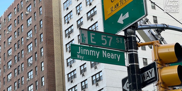 A street sign is unveiled on Wed., Sept. 14, 2022, at the corner of East 57th St and 1st Avenue in Manhattan to honor the late Jimmy Neary, proprietor of nearby Neary's Irish restaurant.
