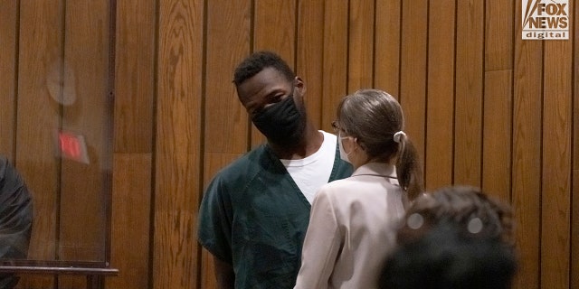 Cleotha Henderson speaks to his attorney, Jennifer Case, while he appeared in court Monday, Sept. 19, 2022.