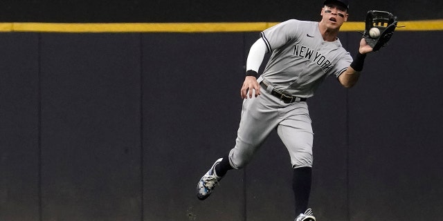 New York Yankees' Aaron Judge catches a ball hit by Milwaukee Brewers' Hunter Renfrew during the first inning of a baseball game, Saturday, Sept. 17, 2022, in Milwaukee.