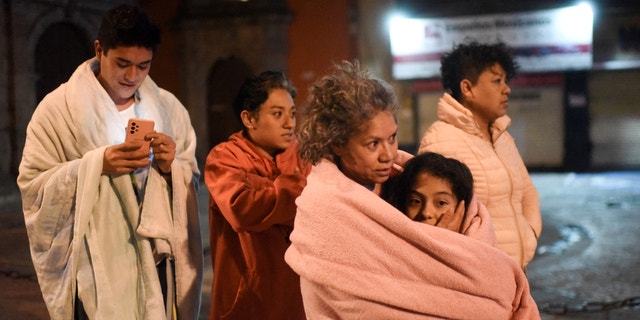 Residents find themselves on a street after a 6.8 magnitude earthquake in Mexico City on September 22, 2022.