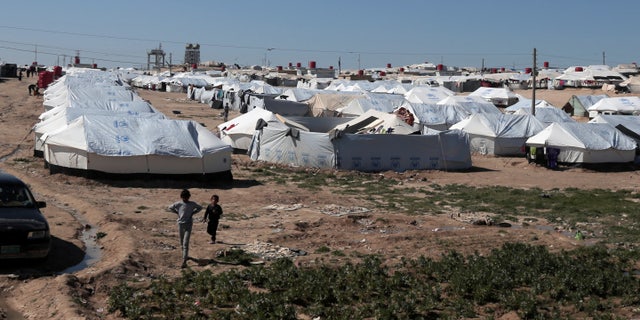 Boys walk at al-Hol displacement camp in Hasaka governorate, Syria, March 8, 2019. 