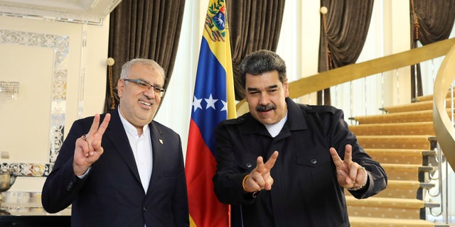 Venezuelan President Nicolas Maduro, right, meets with Iranian Oil Minister Javad Owji in Tehran, Iran, June 13, 2022. 