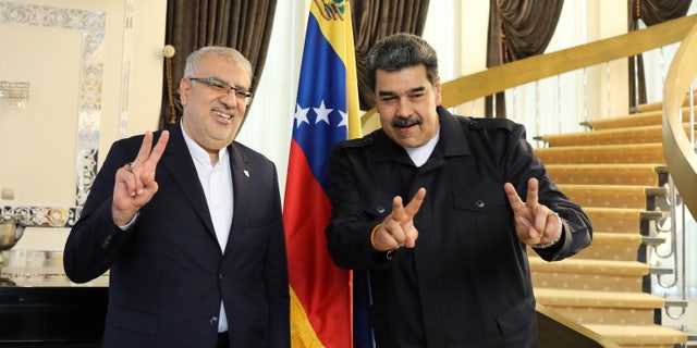 Venezuelan President Nicolas Maduro (right) meets with Iran's Oil Minister Javad Ouji in Tehran, Iran June 13, 2022. 