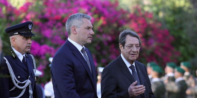 Cypriot President Nicos Anastasiades and Austrian Chancellor Karl Nehammer walk during a welcome ceremony at the Presidential Palace in Nicosia, Cyprus July 13, 2022. 
