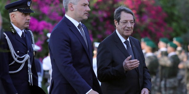 Cypriot President Nicos Anastasiades and Austrian Chancellor Karl Nehammer walk during a welcome ceremony at the Presidential Palace in Nicosia, Cyprus July 13, 2022.