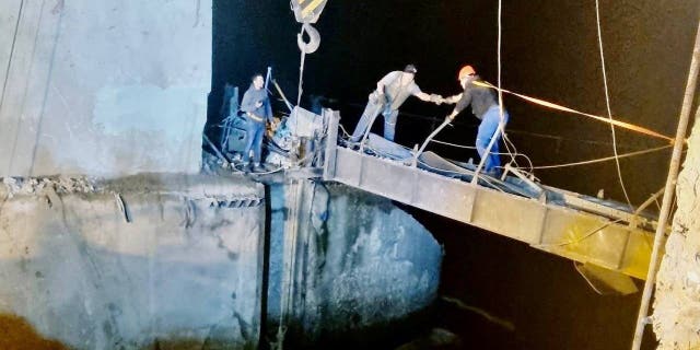 Workers repair a hydraulic structure damaged by a Russian missile strike, amid Russia's attack on Ukraine, in Kryvyi Rih, Ukraine, in this handout picture released Sept. 15, 2022.