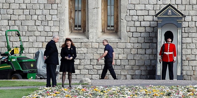 Prince Andrew, Duke of York and Sarah, Duchess of York look at floral tributes laid by people near Windsor Castle.