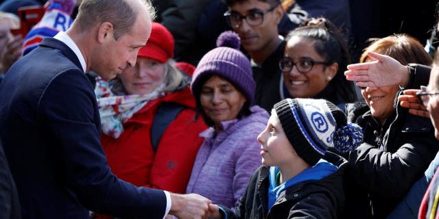 Britain's William, Prince of Wales greets people, while they queue to pay their respects to Britain's Queen Elizabeth, following her death, in London, Sept. 17, 2022. 