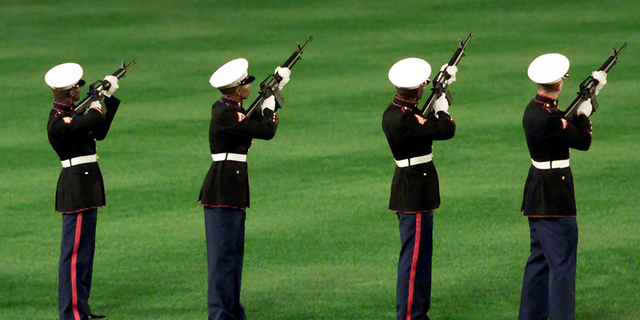 United States Marines fire a 21-gun salute in honor of the victims of the September 11 attacks on New York and Washington, D.C., during a ceremony prior to the New York Mets game against the Atlanta Braves in New York, Sept. 21, 2001. This is the first baseball game to be held in New York since the attacks on the World Trade Center September 11. 