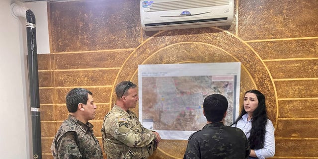 CENTCOM chief Gen. Erik Kurilla consults with camp al-Hol personnel as he assesses the condition of the camp.
