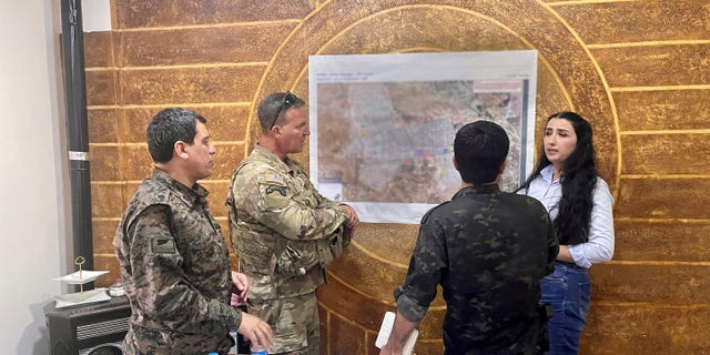 CENTCOM chief Gen. Erik Kurilla consults with camp al-Hol personnel as he assesses the condition of the camp.