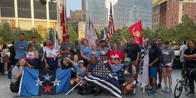 Participants in the 9/11 Promise Run last year proudly wave flags at the finish line on Sept. 11, 2021.