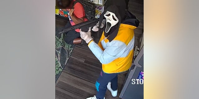 One of the armed robbery suspects donned a ghoulish mask and what appeared to be an assault rifle.