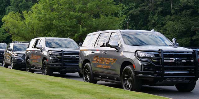FILE- Several Cobb County police cruisers parked in a row. Jacqun Brown ended up incarcerated at the very jail where he was working after he allegedly beat an inmate.