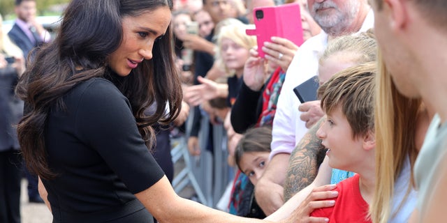 Meghan Markle greets a mourner outside of Windsor Castle following Queen Elizabeth II's death.