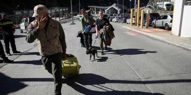 Travelers from Russia cross the border to Georgia at the Zemo Larsi/Verkhny Lars station, Georgia September 26, 2022. 