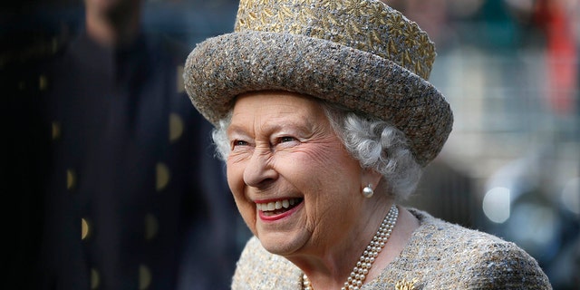 Queen Elizabeth II smiles as she arrives before the opening of the Flanders Fields Memorial Garden at Wellington Barracks Nov. 6, 2014, in London.