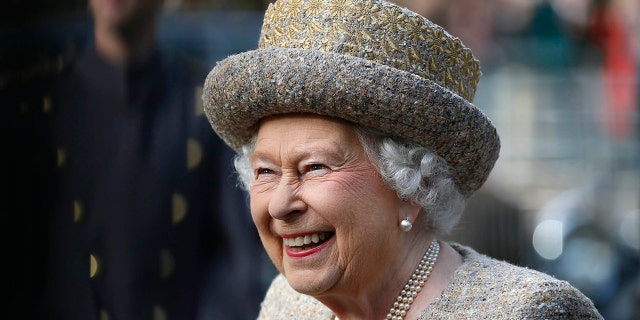 Queen Elizabeth II smiles as she arrives before the opening of the Flanders Fields Memorial Garden at Wellington Barracks Nov. 6, 2014, in London.