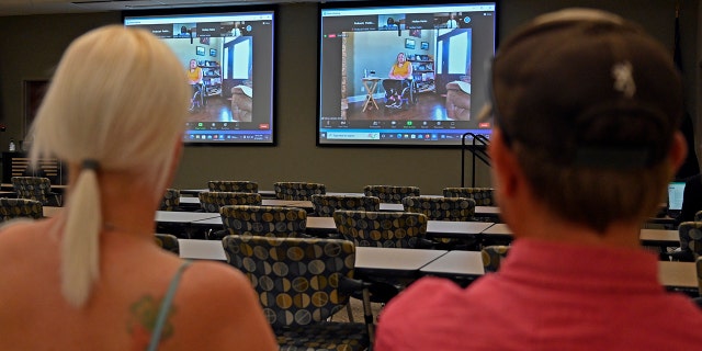 Members of the public watch testimony during the zoom broadcast of the Michael Carneal parole hearing at the West Kentucky Community and Technical College in Paducah, Ky., Monday, Sept. 19, 2022.