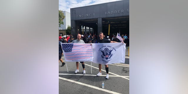 Runner Ryan McGowan (right) and his brother hold up flags in Philadelphia while participating in the 2019 9/11 Promise Run.