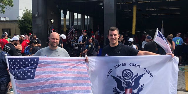 Runner Ryan McGowan (right) and his brother hold up flags in Philadelphia while participating in the 2019 9/11 Promise Run.