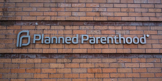 Planned Parenthood sign isolated from damaged clinic in Oregon. 
