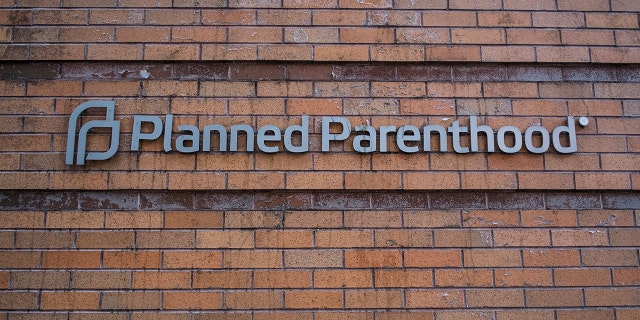 Planned Parenthood sign isolated from damaged clinic in Oregon. 