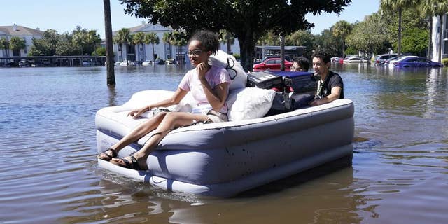 Students at the University of Central Florida are shown using inflatable mattresses to evacuate an apartment complex near the campus that was completely flooded by Hurricane Ian in Orlando, Florida. "heed the warnings of local authorities," Fox News medical contributor Dr. Janette Nesheiwat said: