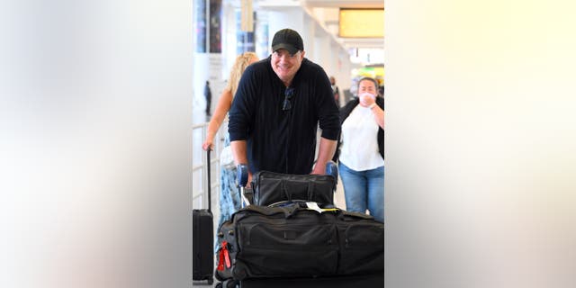 Brendan Fraser pushed a luggage cart through the airport after receiving a six-minute standing ovation for his role in "The Whale" at the Venice Film Festival Sunday.