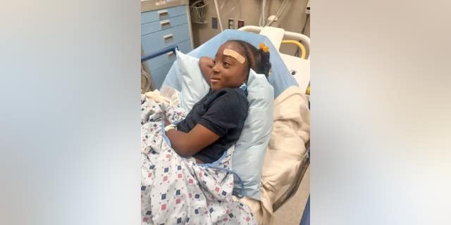 A girl was hospitalized after a stray bullet grazed her head Thursday night during a drive-by shooting near Temple University in Philadelphia.
