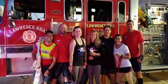 Runner Ryan McGowan (far right) and his team pose for a photo in front of a fire truck at Lawrenceville Fire Department, which hosted them for breakfast on Sept. 11, 2019 — day three of the 9/11 Promise Run that year.