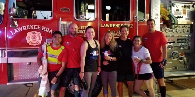Runner Ryan McGowan (far right) and his team pose for a photo in front of a fire truck at Lawrenceville Fire Department, which hosted them for breakfast on Sept. 11, 2019  day three of the 9/11 Promise Run that year.