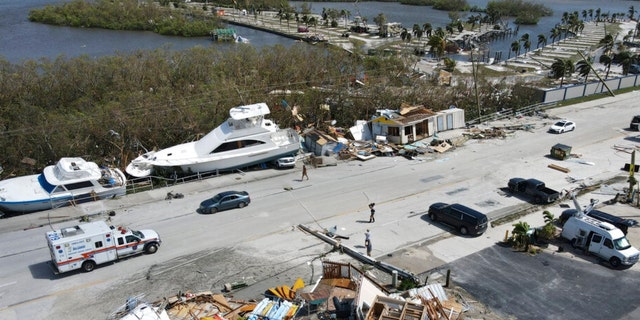 In this photo taken by a drone, the two-story Getaway Marina building, front, lies reduced to rubble as displaced boats rest along the roadside and a trailer park, at top, lies nearly devoid of homes, following the passage of Hurricane Ian, on San Carlos Boulevard in Fort Myers Beach, Florida, Thursday, Sept. 29, 2022. 