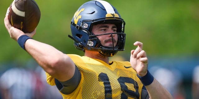 West Virginia quarterback JT Daniels passes during an NCAA college football practice in Morgantown, West Virginia, Saturday, Aug. 8, 2022. The Backyard Brawl returns after a 10-year hiatus on Thursday night, Sept. 1 when 17th-ranked Pitt hosts West Virginia. 