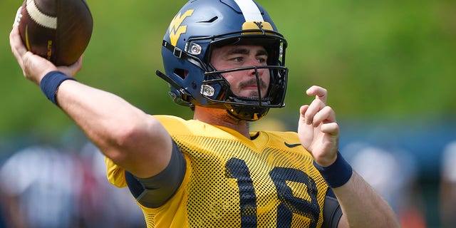 West Virginia quarterback JT Daniels passes during an NCAA college football practice in Morgantown, West Virginia, Saturday, Aug. 8, 2022. The Backyard Brawl returns after a 10-year hiatus on Thursday night, Sept. 1 when 17th-ranked Pitt hosts West Virginia. 