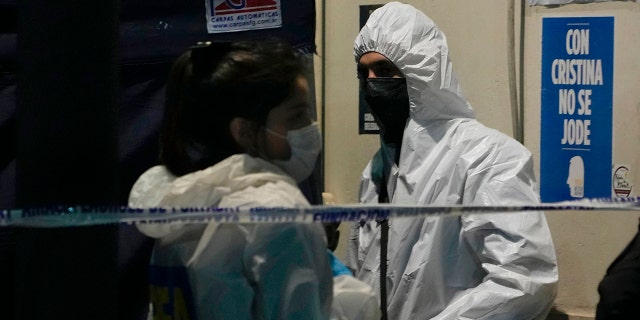 Police investigators stand at the scene where a man pointed a gun at Argentina's Vice President Cristina Fernandez during an event in front of her home in the Recoleta neighborhood of Buenos Aires, Argentina, Thursday, Sept. 1, 2022. 