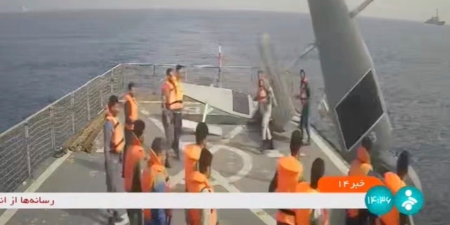 In this frame grab from Iranian state television, Iranian navy sailors throw an American sea drone overboard in the Red Sea Thursday, Sept. 1, 2022.