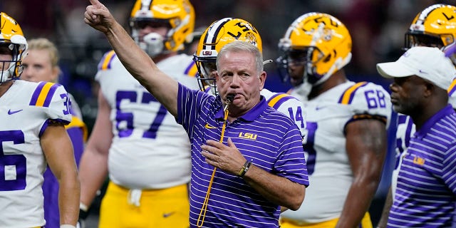 LSU head coach Brian Kelly blows the whistle before an NCAA college football game against Florida State in New Orleans, Sunday, Sept.