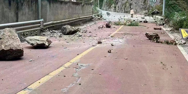 In this photo provided by China's Xinhua News Agency, fallen rocks are seen on a road near Lengqi Town in Luding County of southwest China's Sichuan Province Monday, Sept. 5, 2022. 