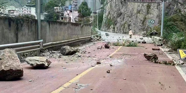 In this photo provided by China's Xinhua News Agency, fallen rocks are seen on a road near Lengqi Town in Luding County of southwest China's Sichuan Province Monday, Sept. 5, 2022.