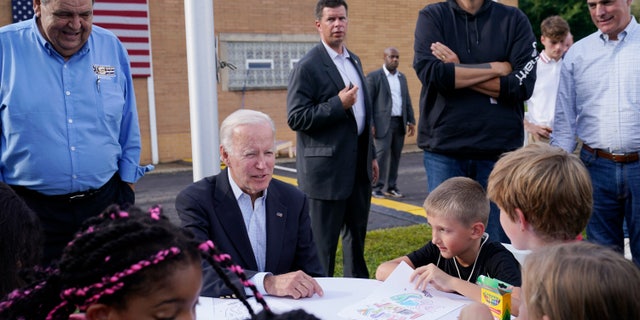 President Joe Biden sits and talks to children before speaking at the National Steelworkers' Local Union 2227 event in West Mifflin, Pennsylvania, September 5, 2022.